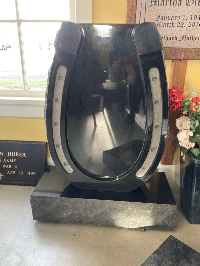 A horse shoe-shaped tombstone