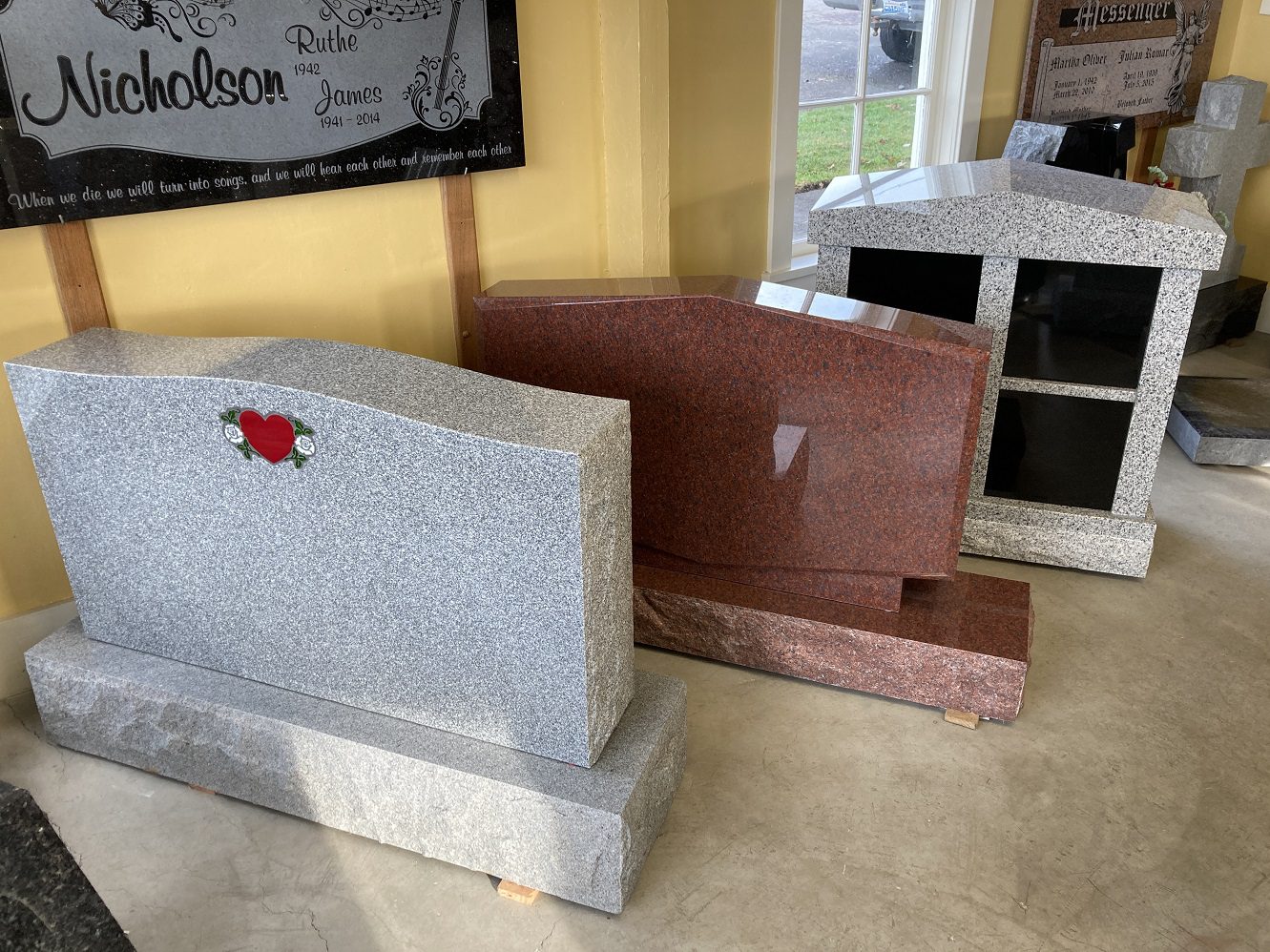 Three tombstone, one with a heart