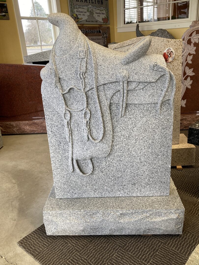 A granite headstone with engraved symbols