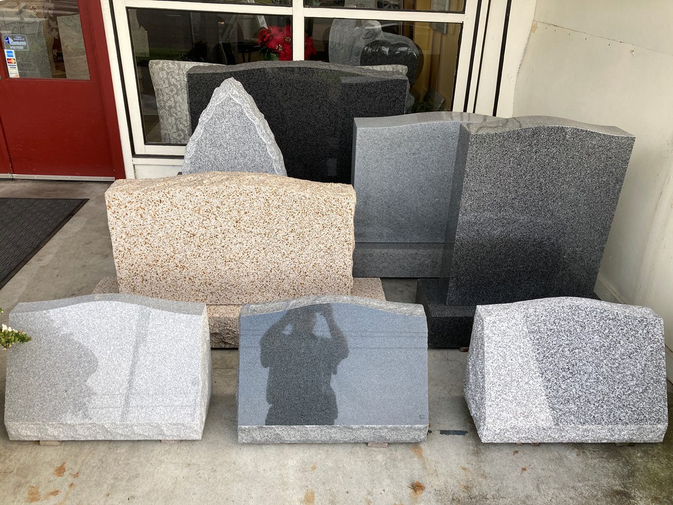 Different shapes of granite tombstones in front of the store