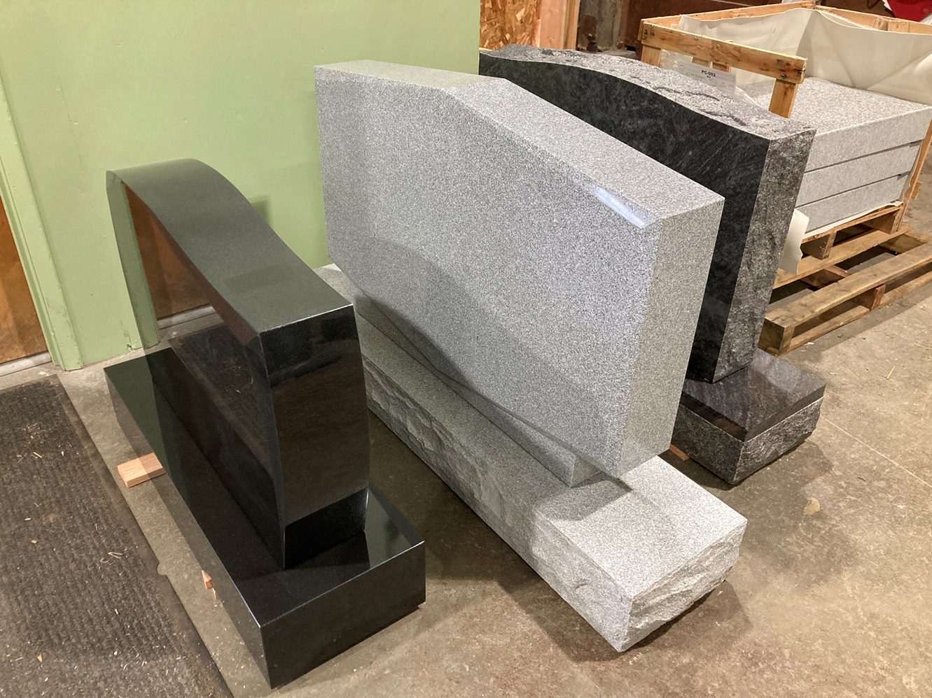 Two black and one gray granite headstones